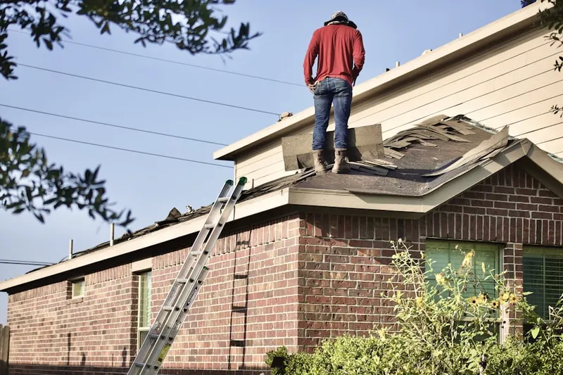 Professional roofer working on a residential roof in Marshalls Corner